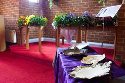 Ceramic dishes by Hebe in  front  of  sanctuary  area  flower  display